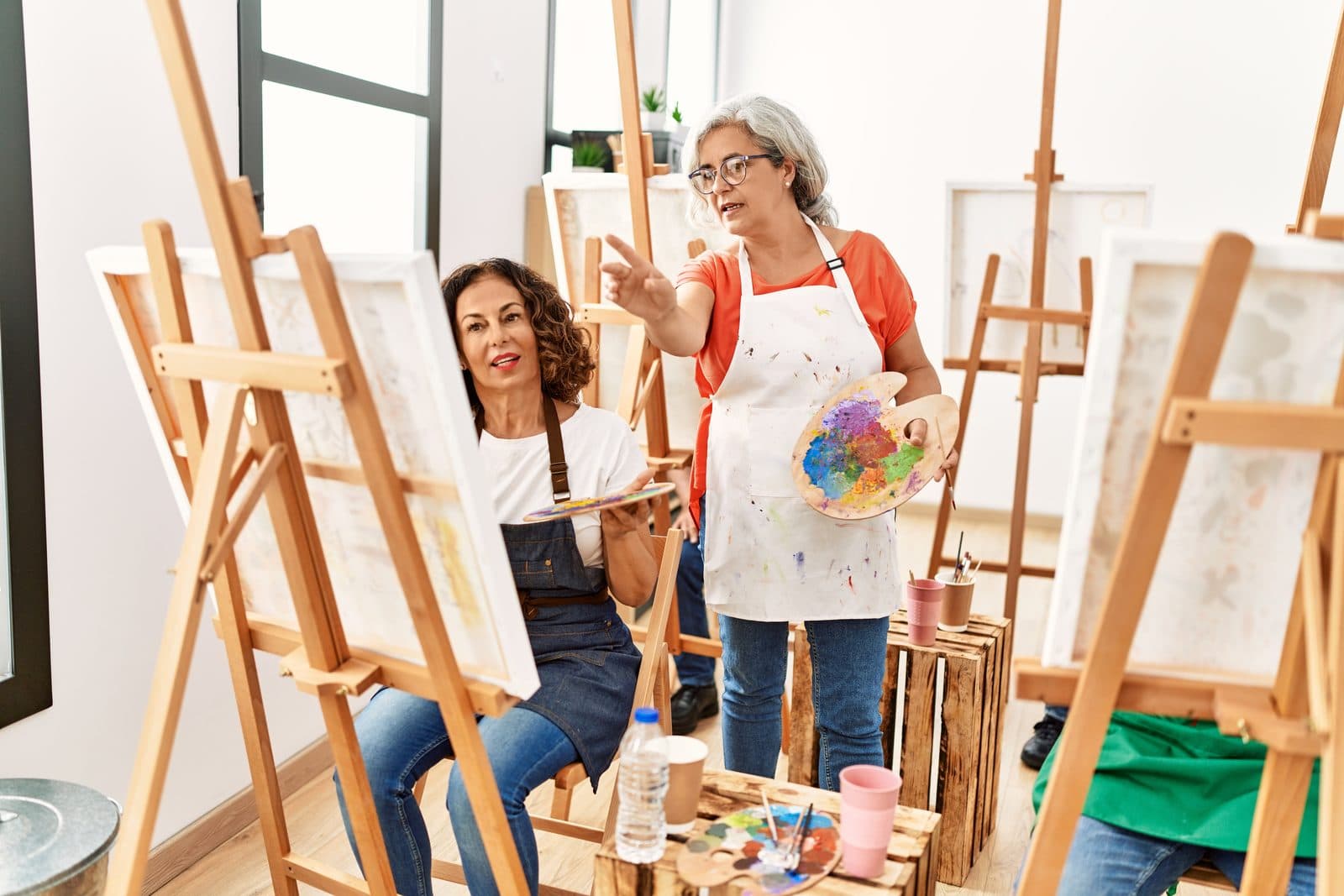 Facilitator encouraging a participant at the easel