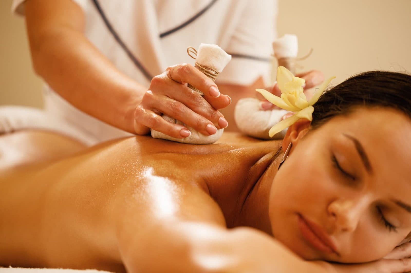 Client relaxing during a warm oil massage