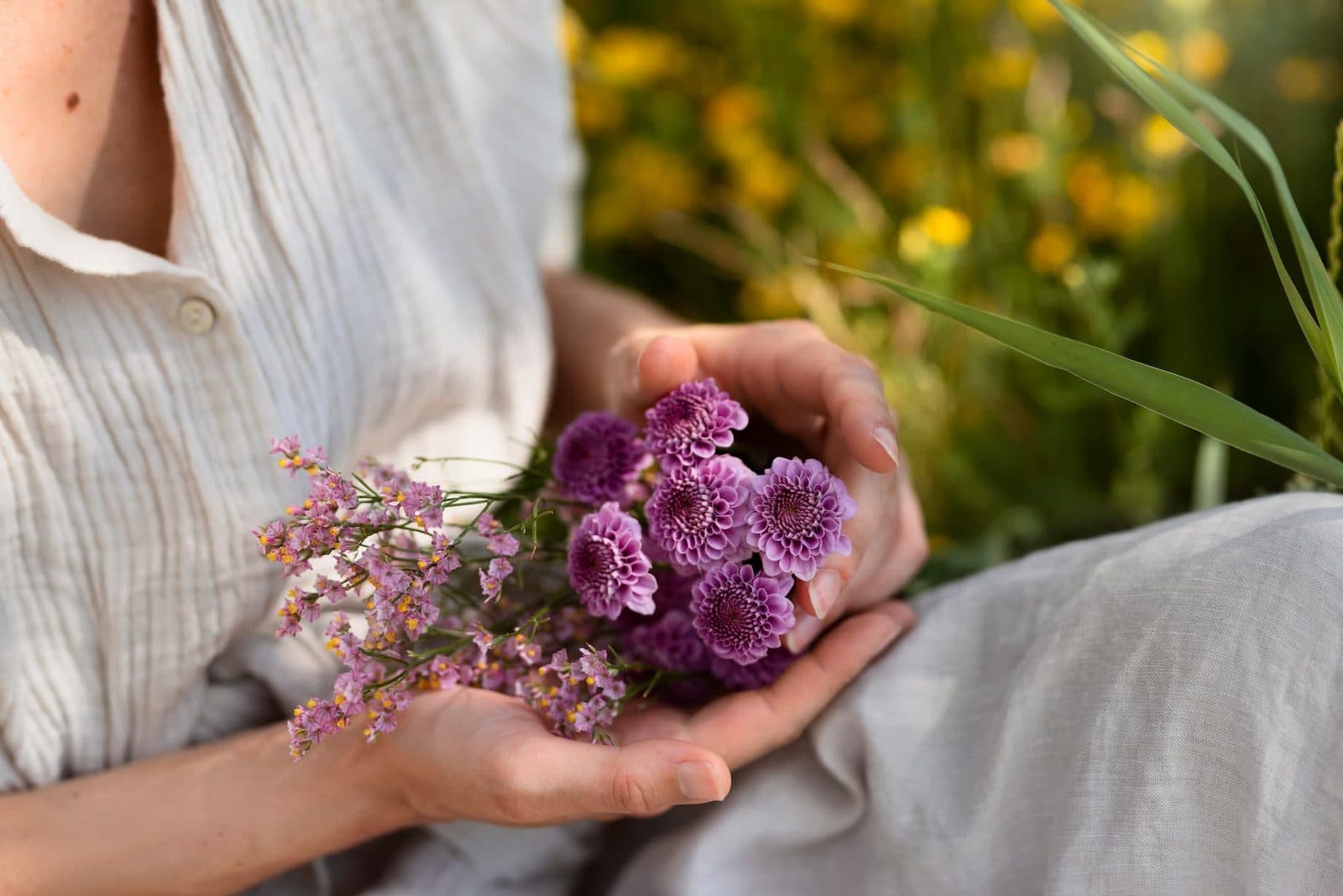 Hands holding a bunch of fresh flowers