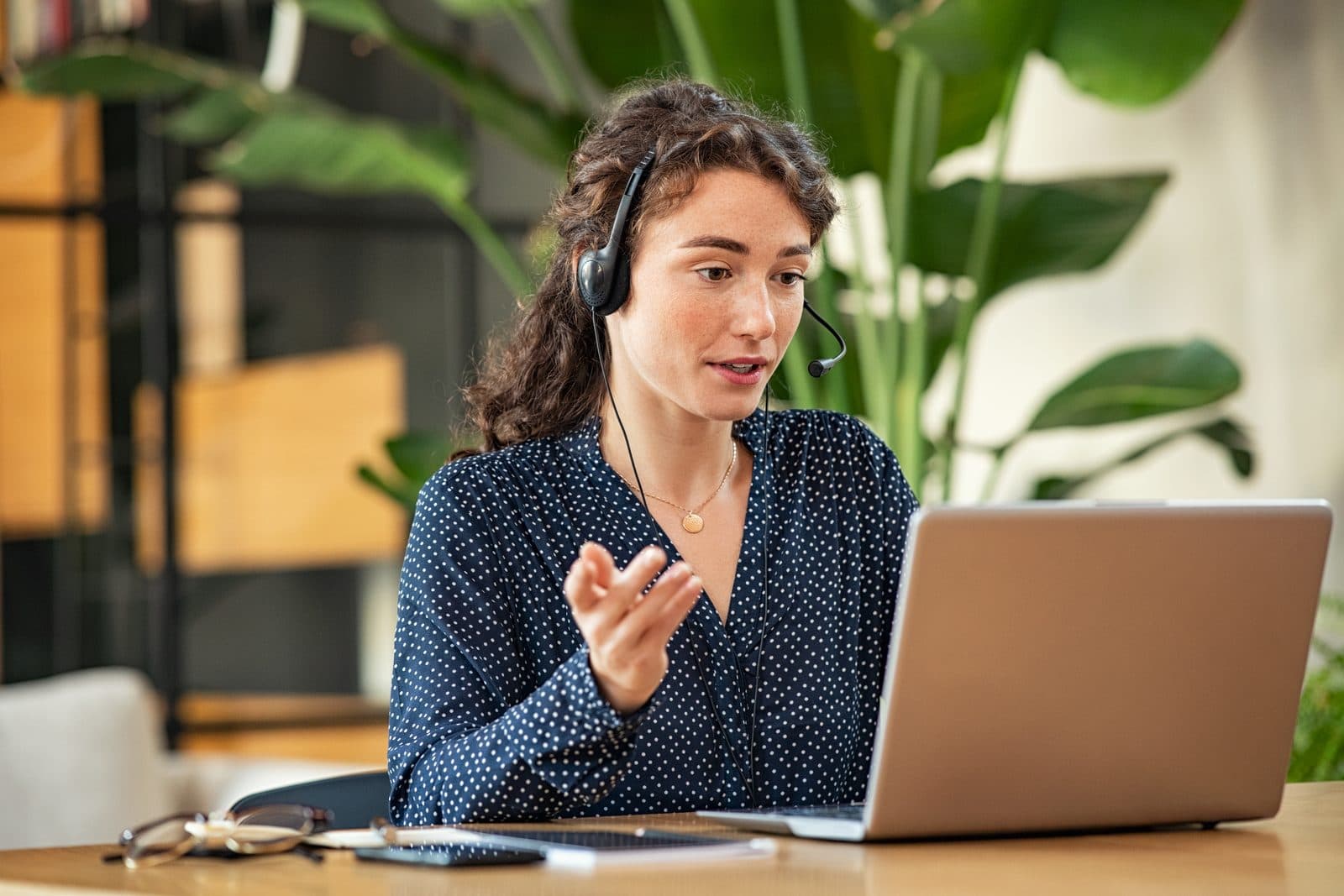 Practitioner with a headset leading a live online consultation