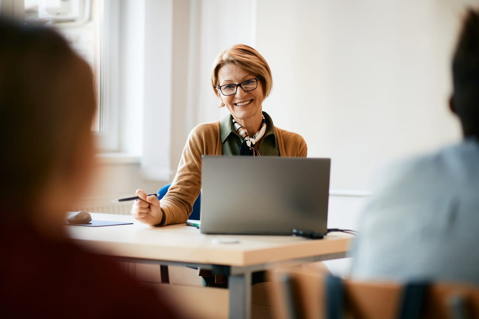 Woman smiling at her laptop during a live online class