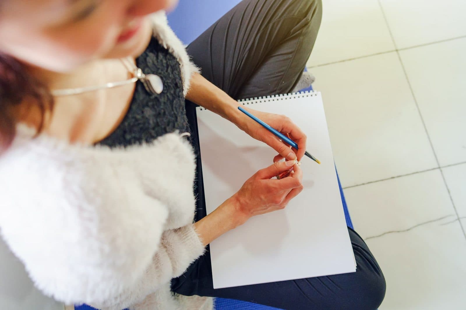 Hand writing in a notebook during a therapeutic writing exercise