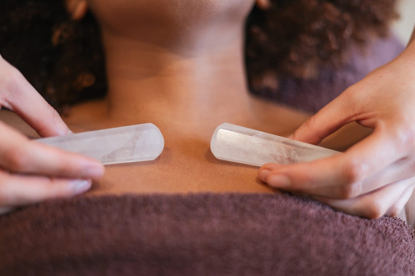 Clear quartz crystals placed on a client's chest during a crystal healing session