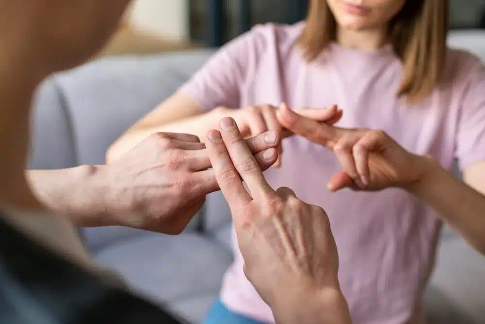 Fingertips tapping the side of the hand, the EFT setup point