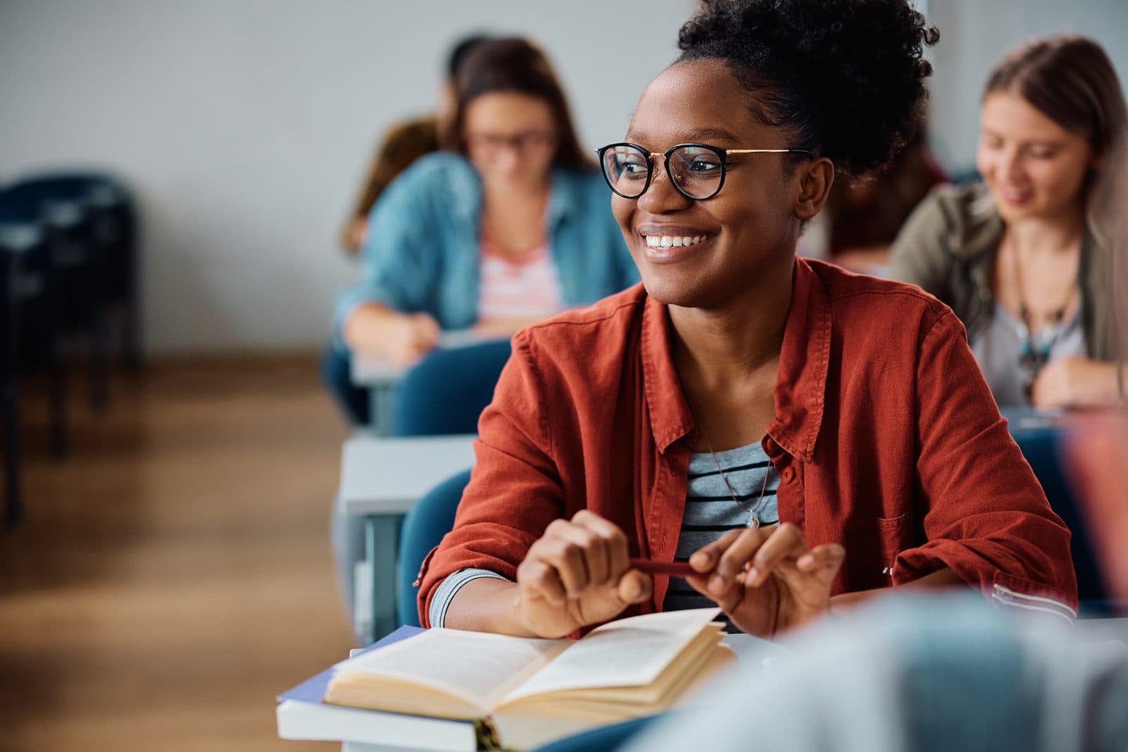 Student smiling over her notes during class