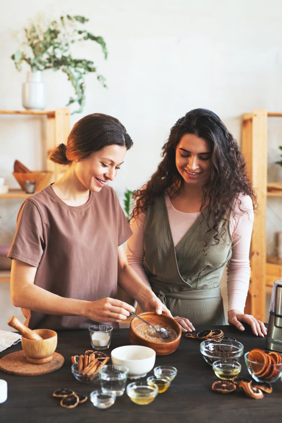 Two students smiling as they work on a natural preparation together