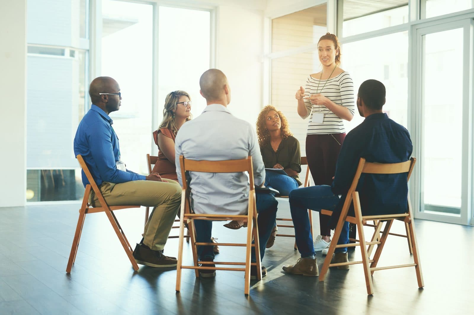 Small group practicing a dialogue exercise in a circle