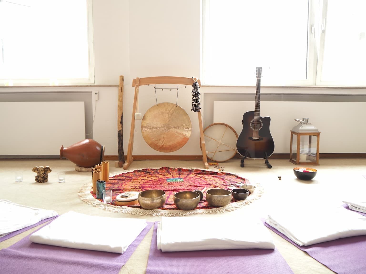 Singing bowls, gong and instruments set out for a sound session