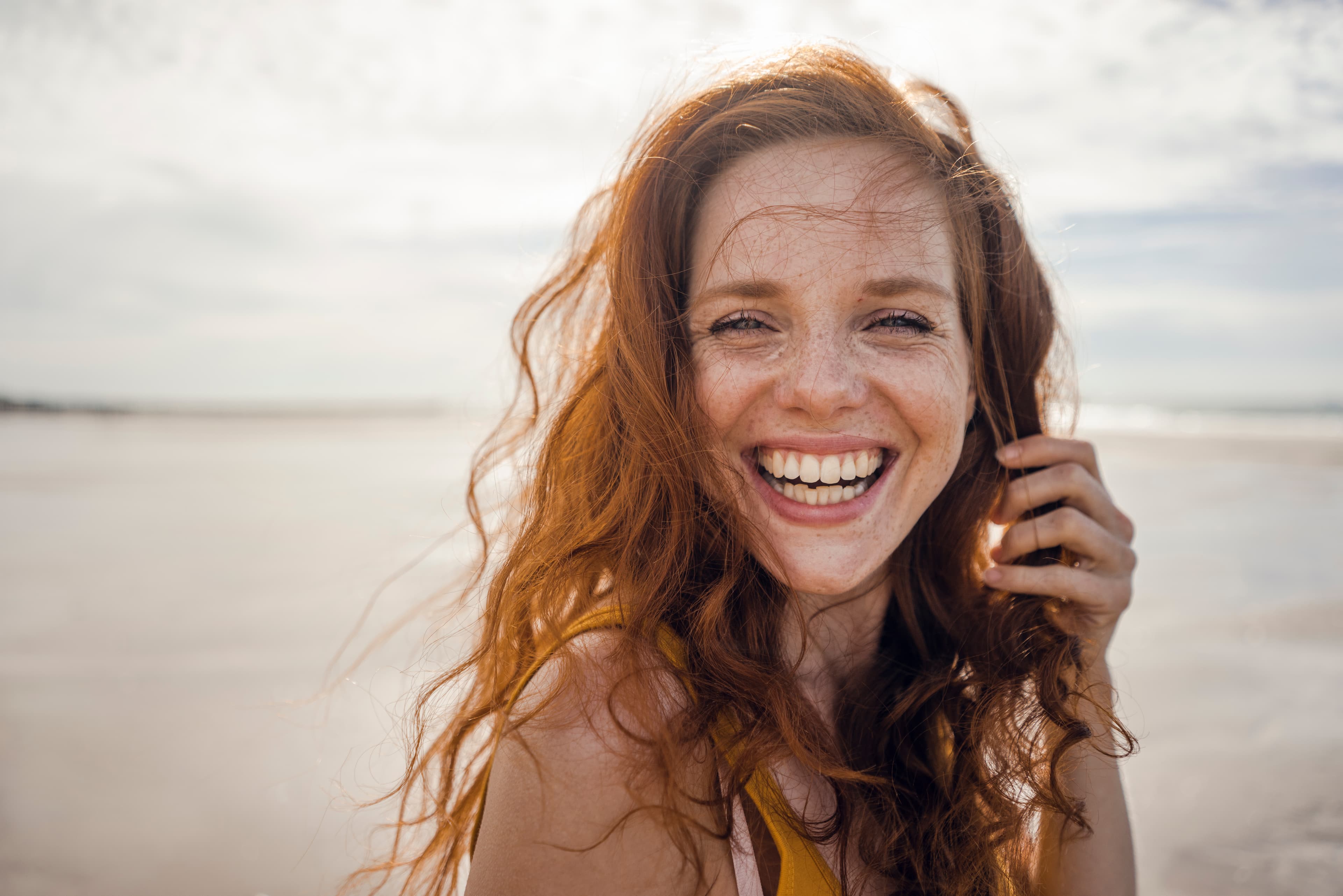 A smiling woman beginning her holistic practitioner training