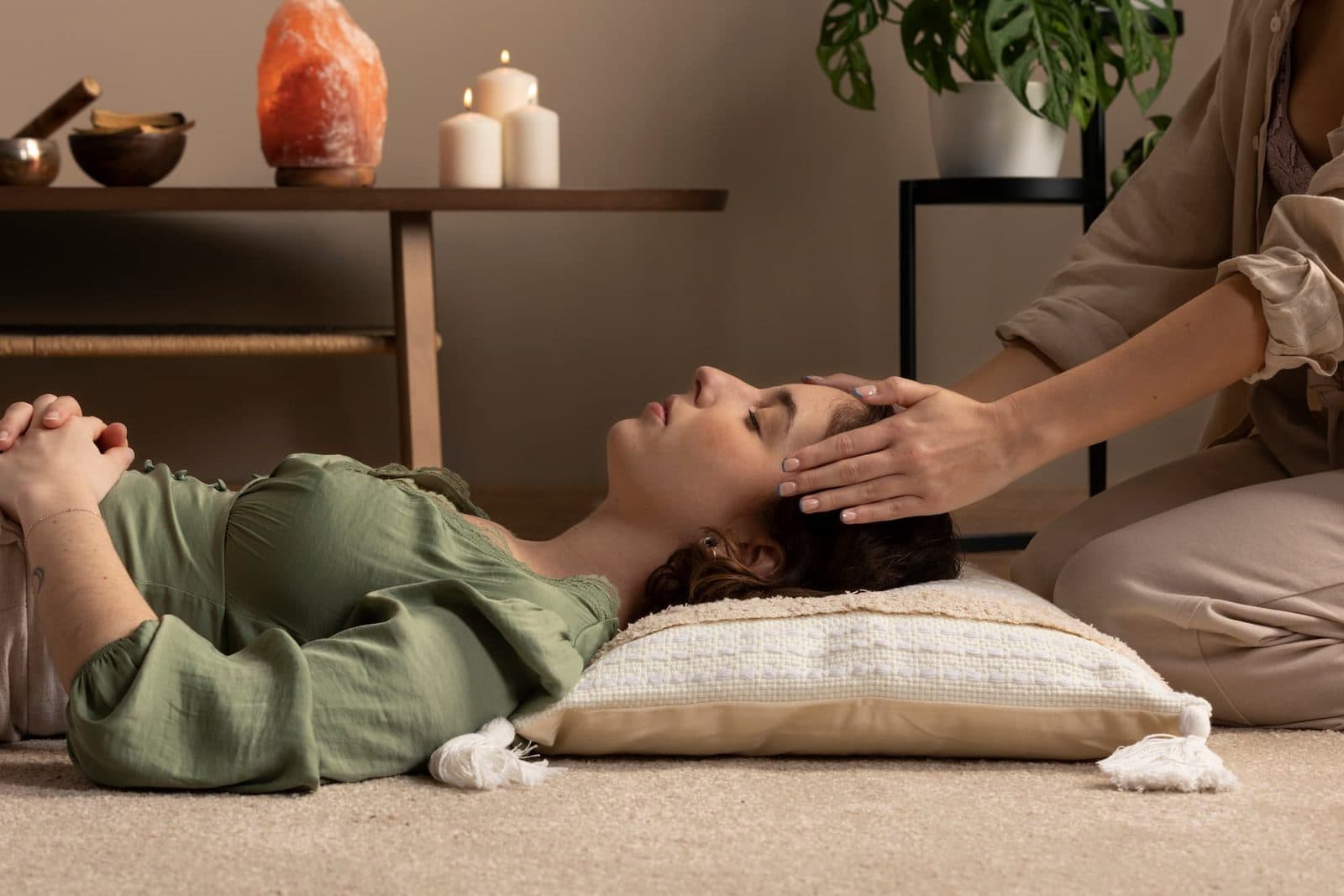 Magnetizer resting her hands at a client's head during a session